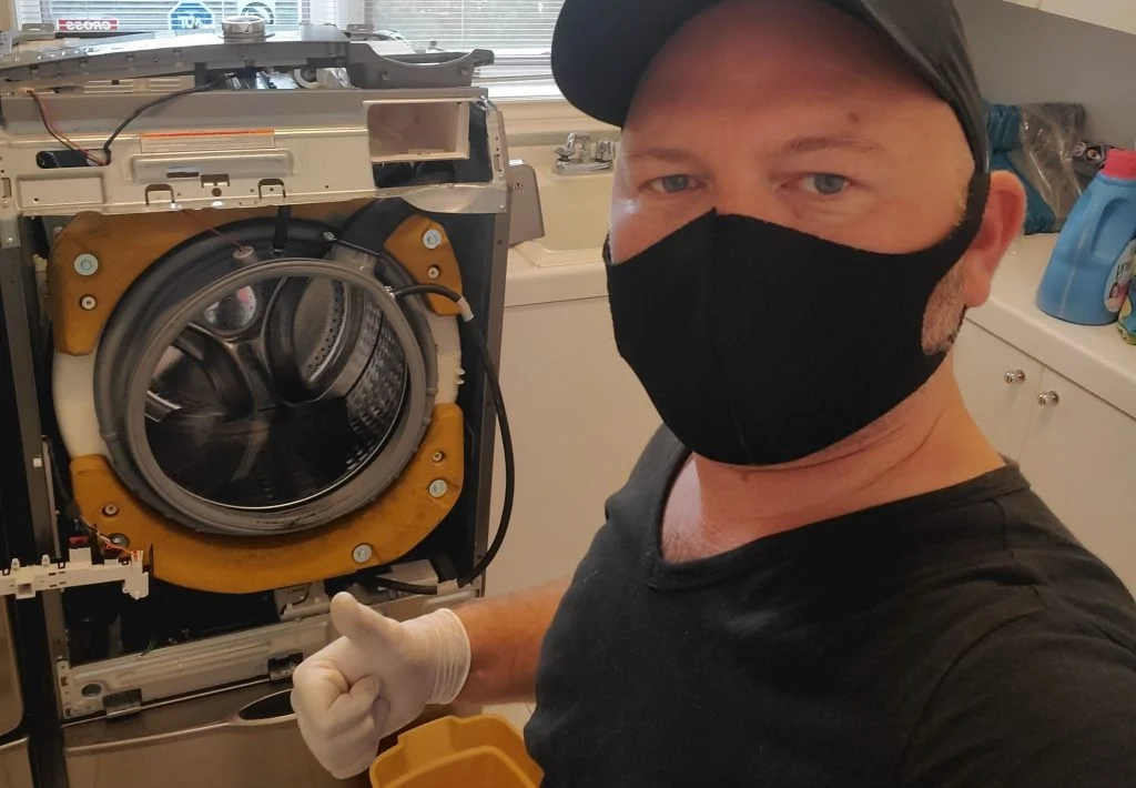 Alpha tech team member repairing washer - washer repair service